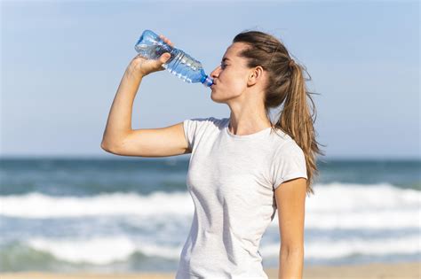 person drinking bottled water